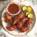Crispy Hot Honey Chicken Tenders served with spicy honey glaze, pickles, and dipping sauce