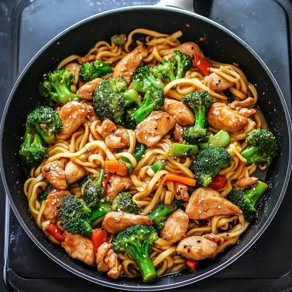 Chicken and broccoli stir fry with noodles in a skillet
