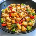 Spicy chicken stir fry with noodles in a wok