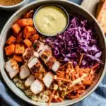 Sweetgreen hot honey chicken bowl with quinoa, grilled chicken, roasted sweet potatoes, shredded carrots, cabbage, and mustard sauce