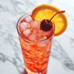 shirley temple drink recipe served with cherry and orange garnish